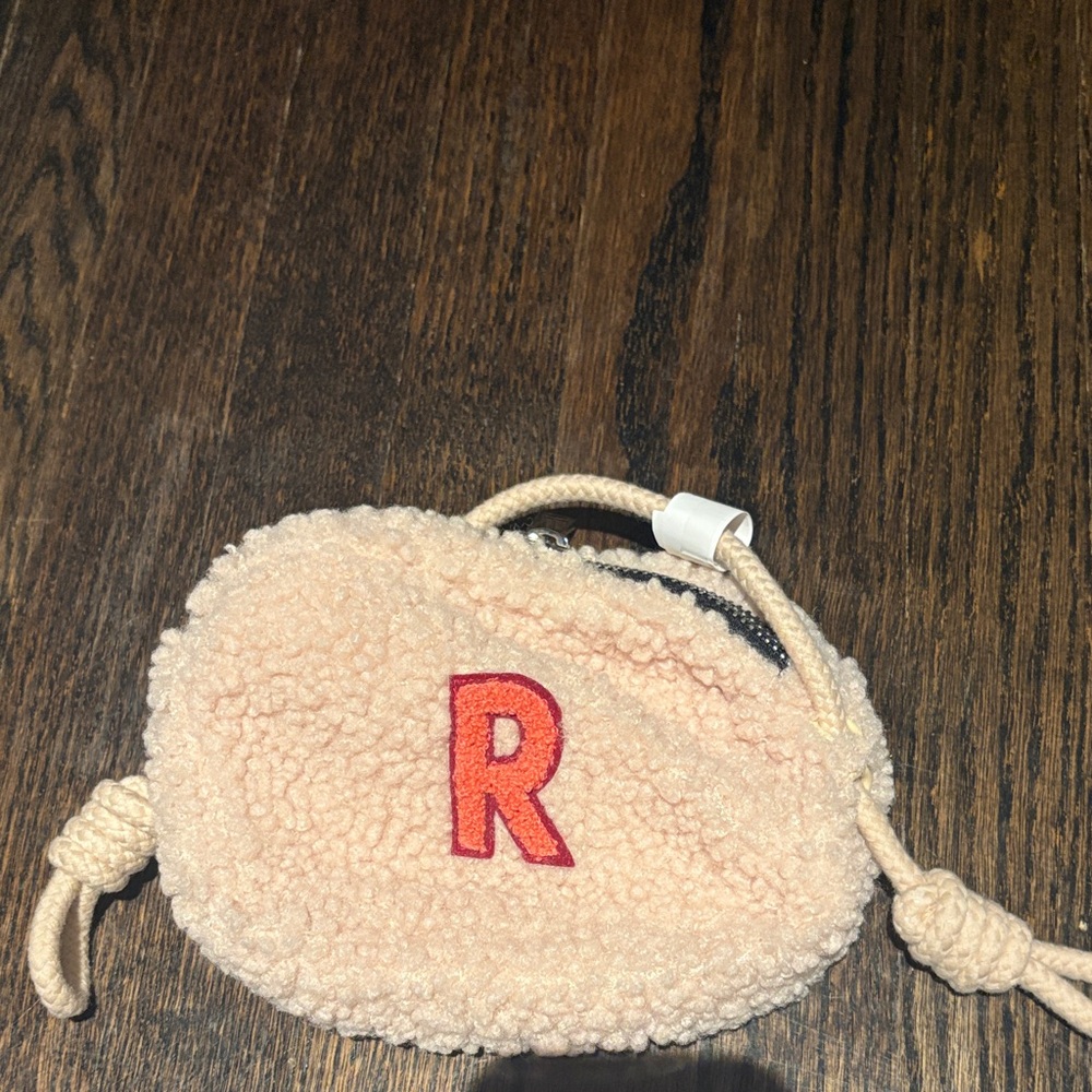 Fuzzy ZARA purse with a pink “R”